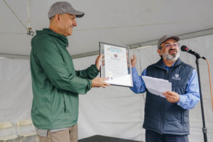 Javier Alberto Soto (left) and David Portillo (right) displaying the Proclamation from Denver Mayor Michael Hancock declaring September 10, 2022 as Strengthening Neighborhoods Day.